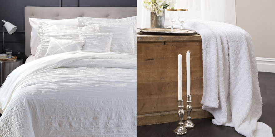 White bedding with linen headboard and white throw on wood chest
